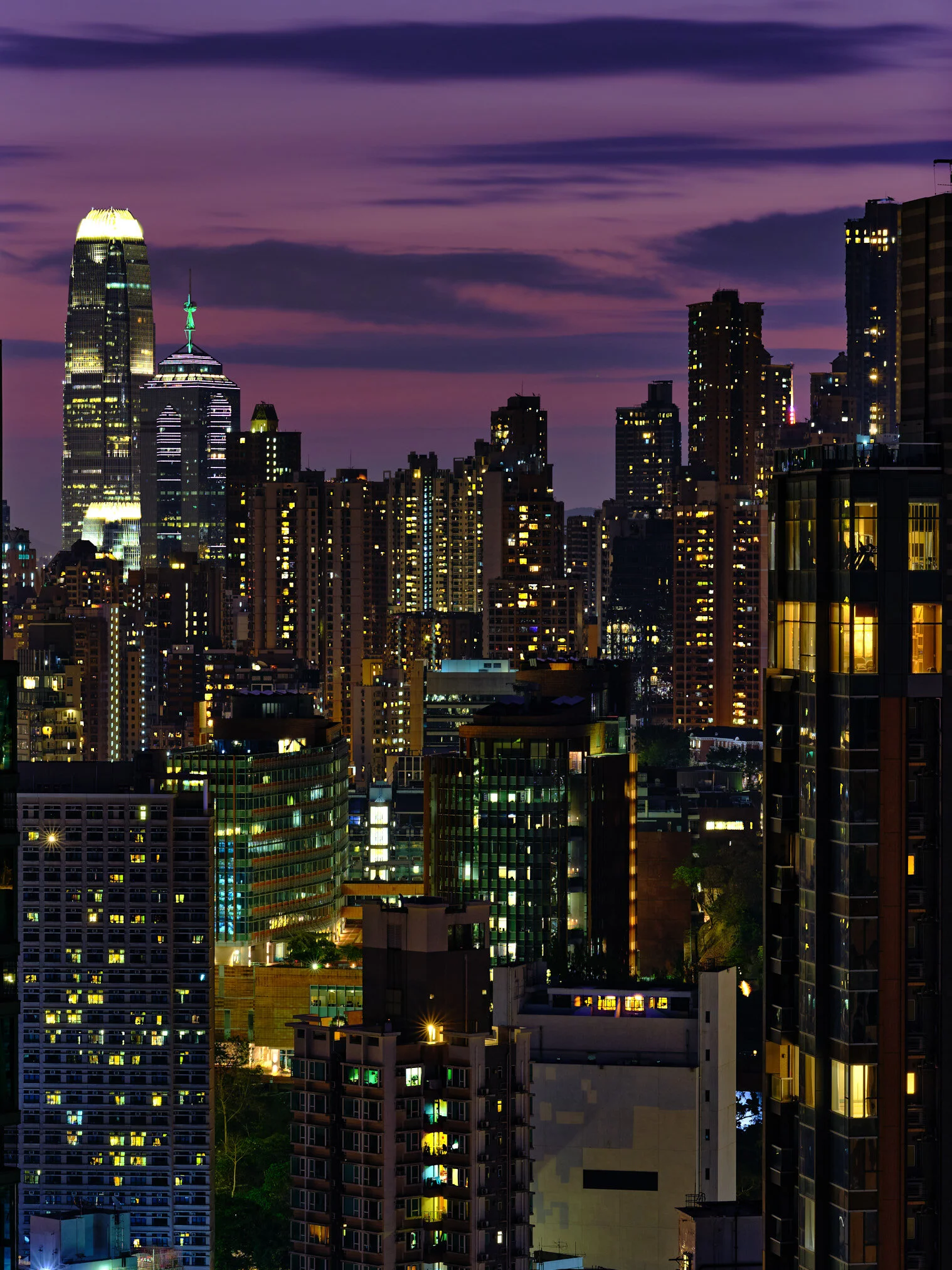 A distant apartment window glowing warm yellow at night