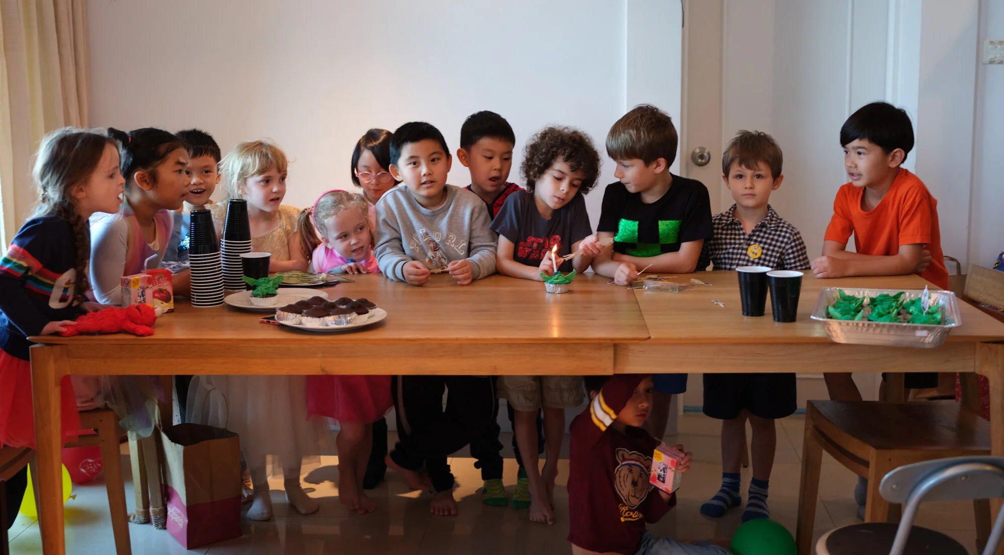 A child sitting alone at a long banquet table